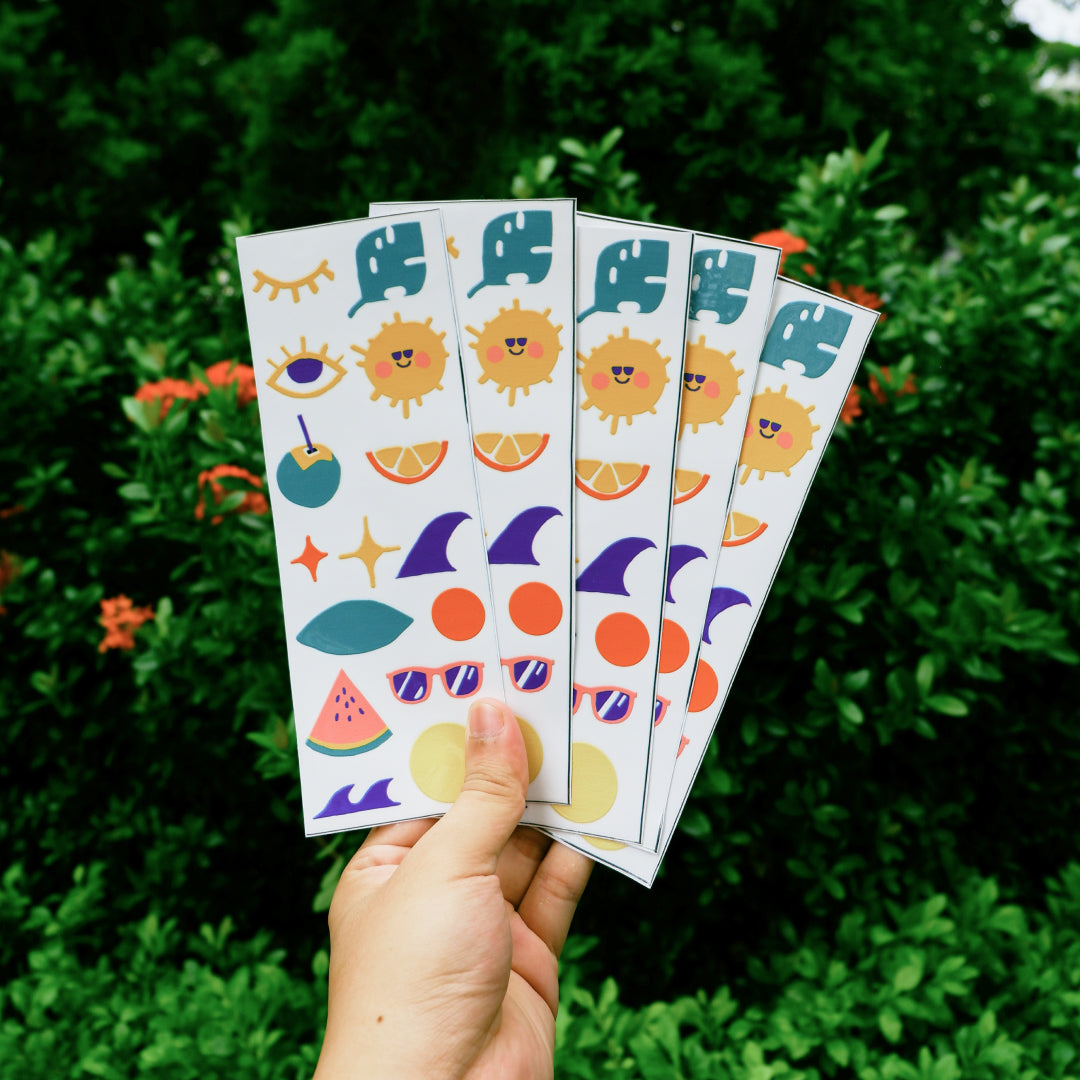 a hand holding 5 summer vibe stickers set